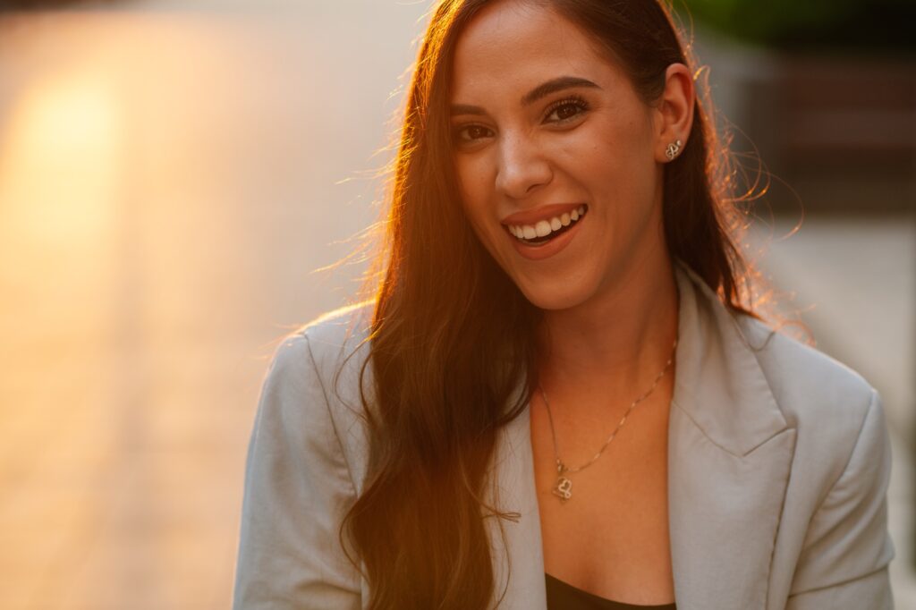 Woman smiling with natural light after receiving cosmetic dental care at Amber Arch Dental in Atlanta, GA.