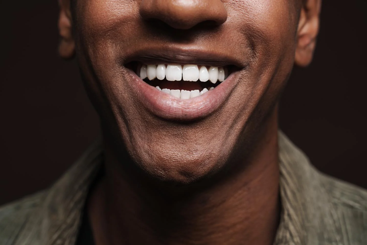 man showing a smooth, natural-looking smile after cosmetic dental bonding at Amber Arch Dental in Atlanta, GA